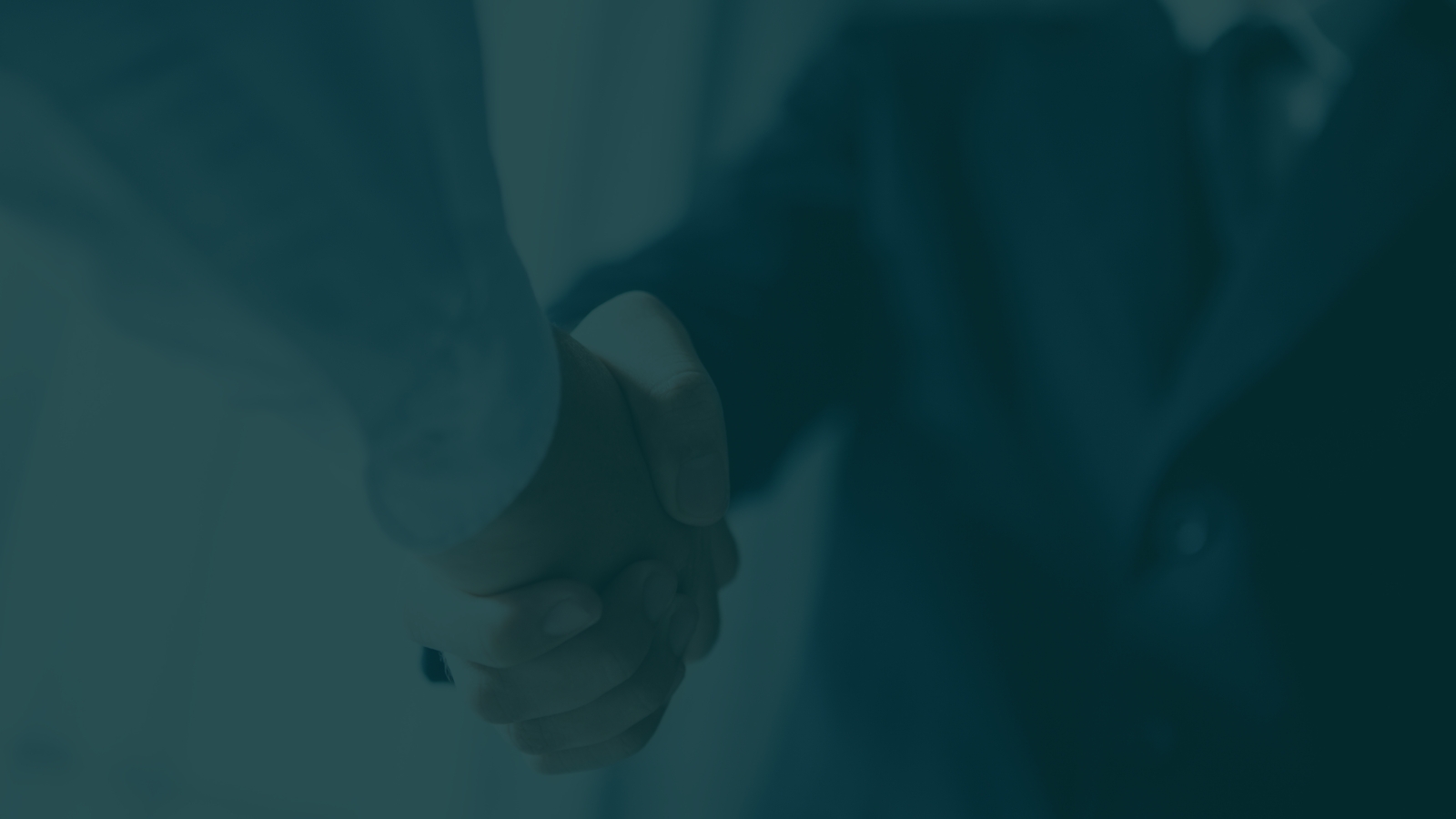 Two investment partners shaking hands over an agreement